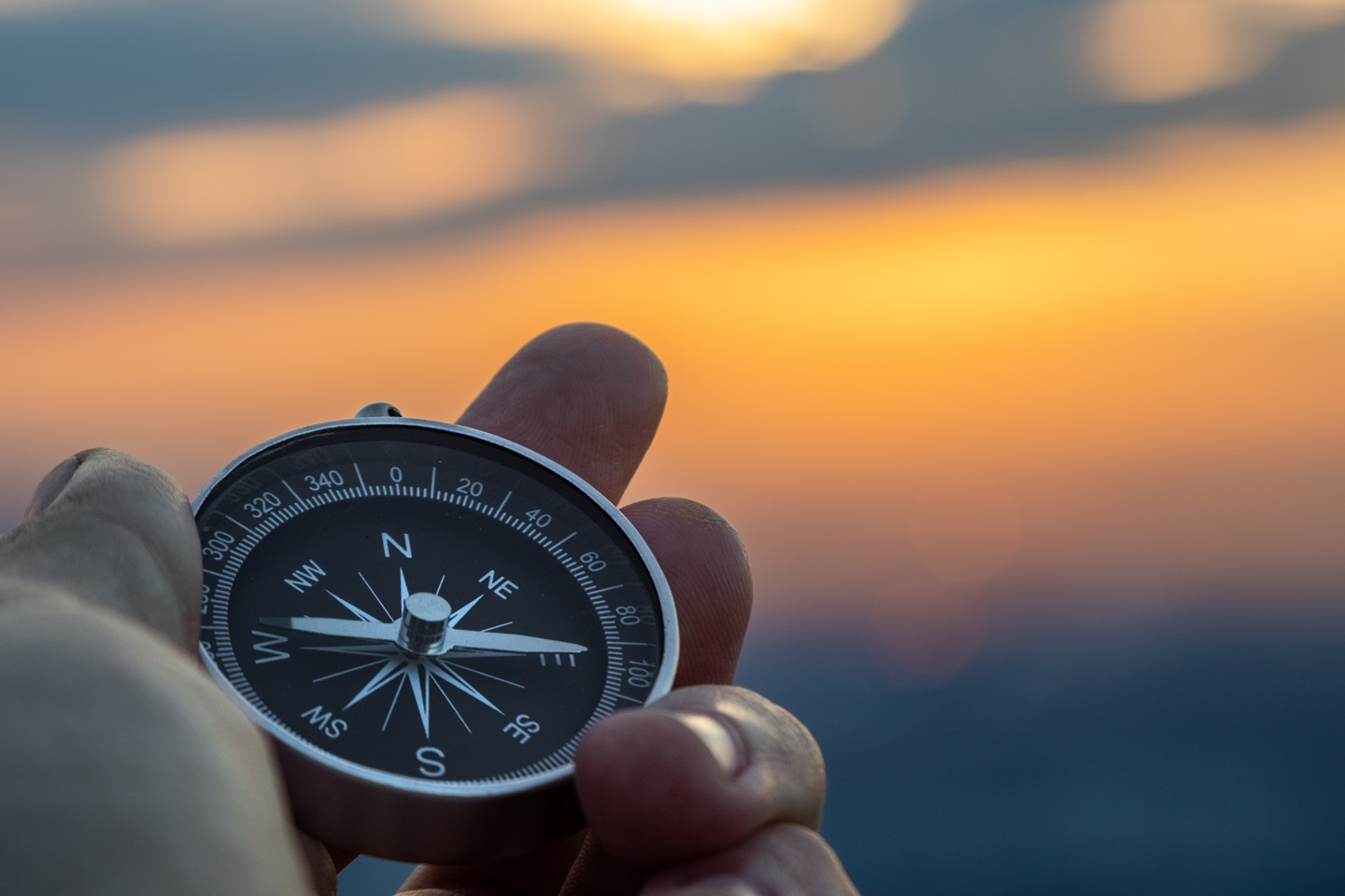 Hand holding compass