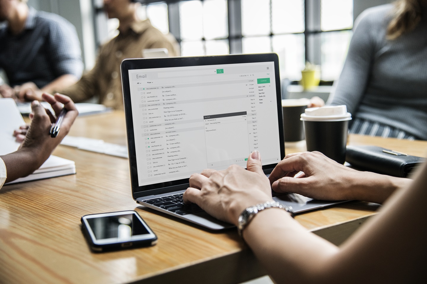 person typing email on laptop