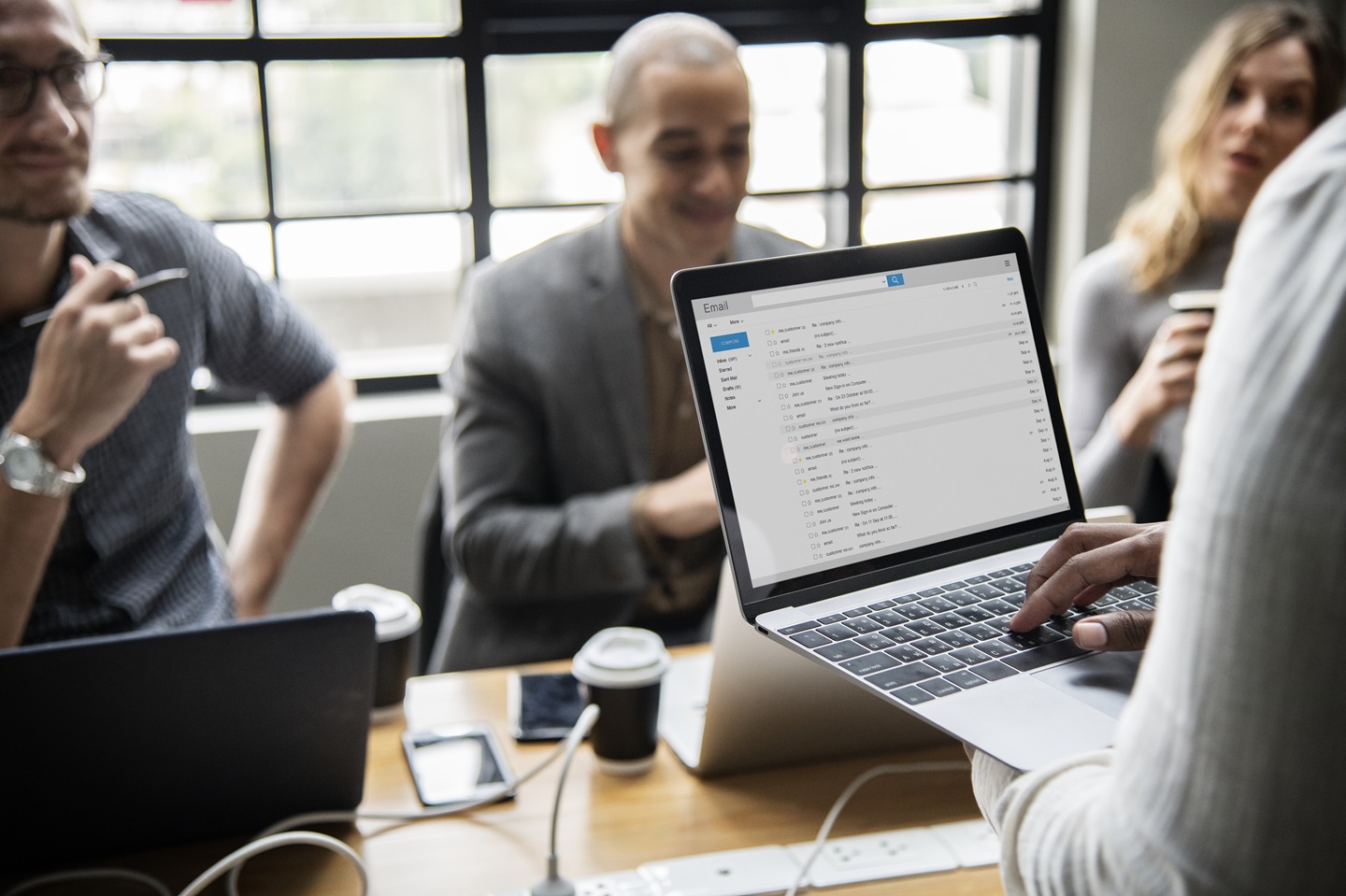 Person using laptop with email inbox on the screen