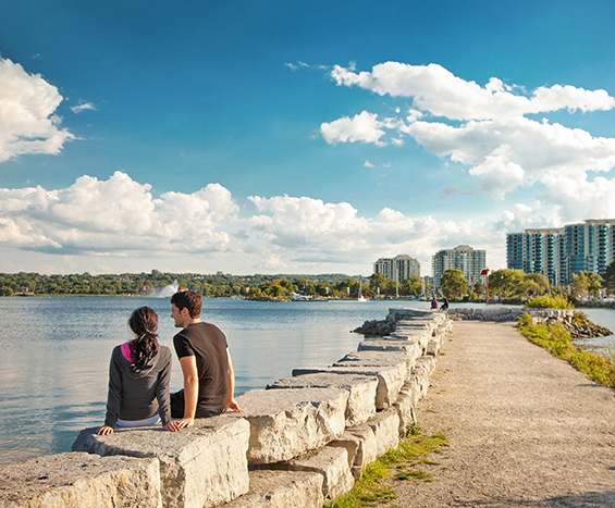 Man and woman sitting next to waterfront in Barrie